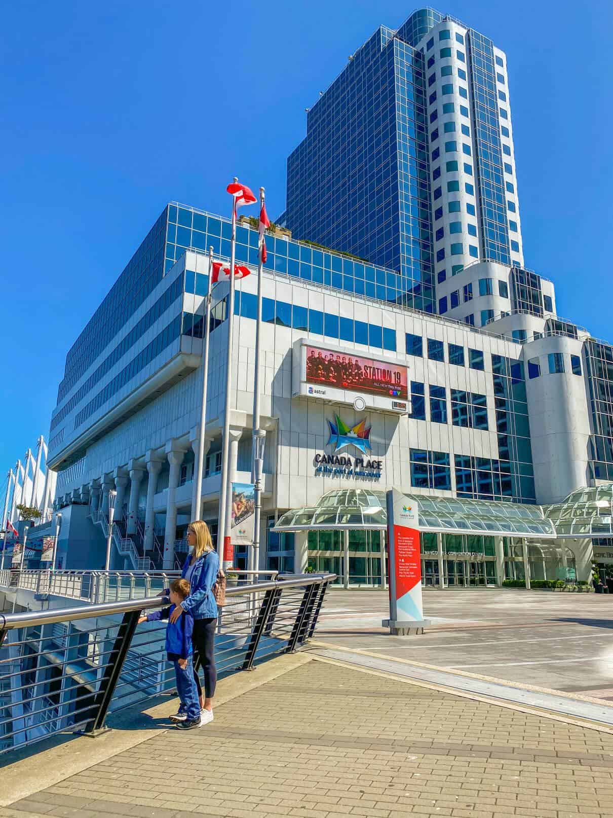 woman and son standing at railing at Canada Place in Vancouver