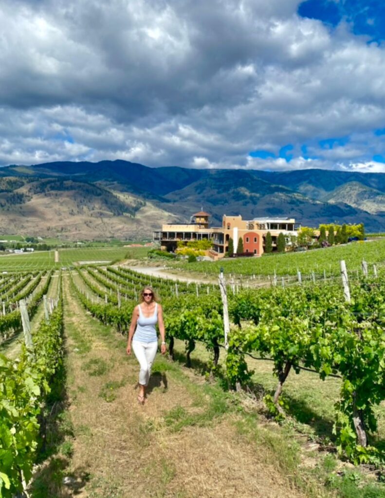 woman walking in vineyards in british columbia