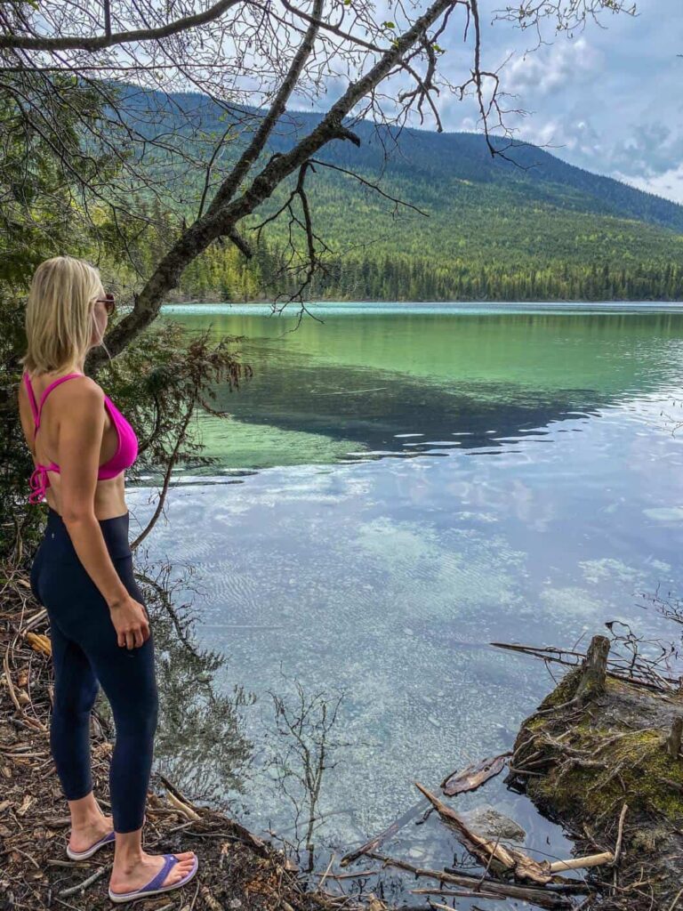 woman looking out at johnson lake bc