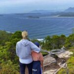 mother and son on trail overlooking ocean