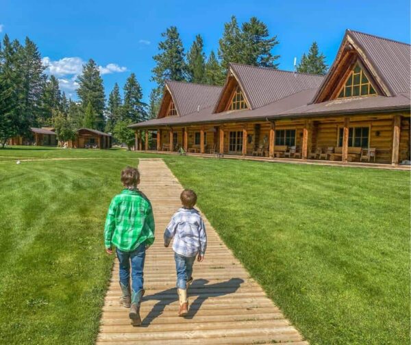 two boys walking on a ranch