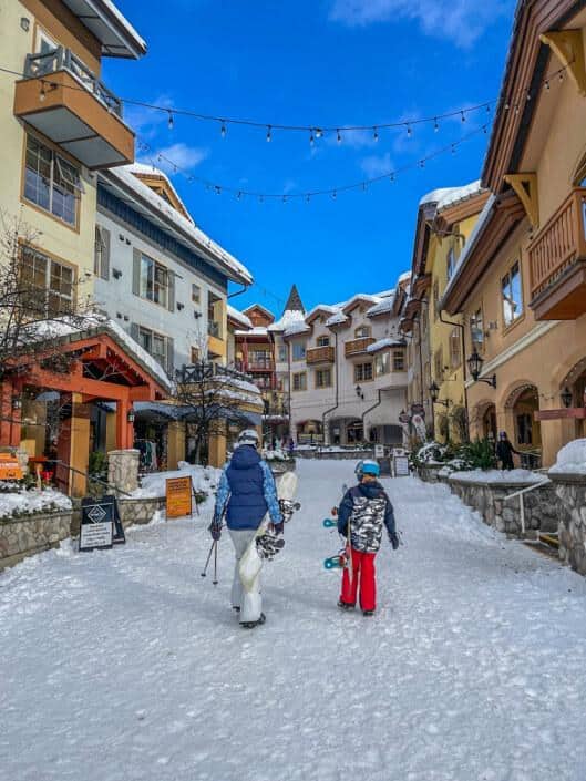 mother and son walking through village