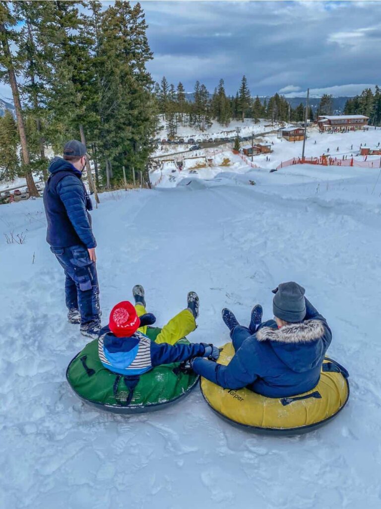 people in snow tubes