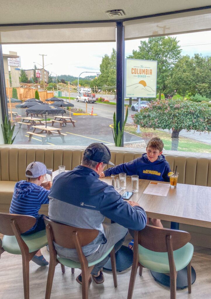 man and sons sitting at diner in kamloops bc