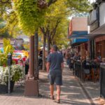 city of kamloops downtown, BC, Canada. 2019 August 10. Ribfest, Hot Nite in the City. Car Show. Victoria street.man walking on the street by the restaurants, flowers and shops in the summer